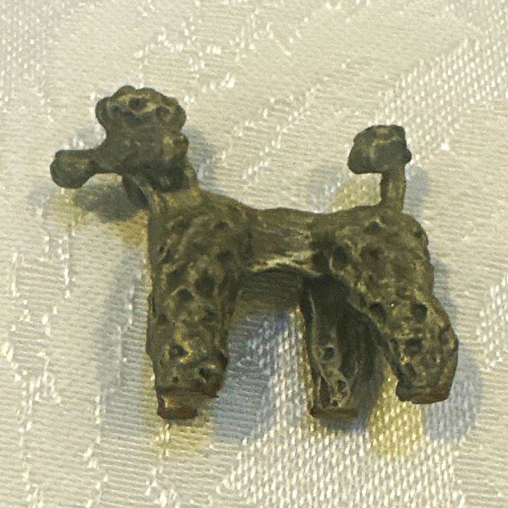 small vintage metal poodle figurine with textured fur
